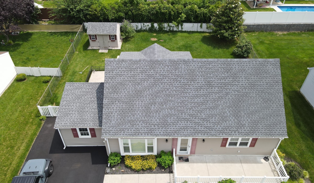 Aerial view of residential home showing well-maintained roof