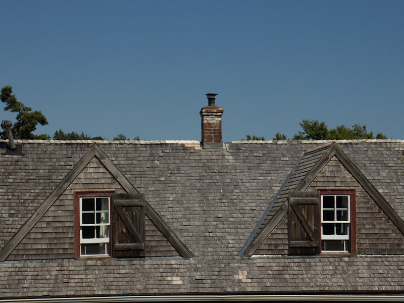 Close-up of shingled roof with dormer windows showing quality installation