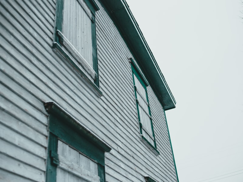 House exterior showing horizontal siding with green window trim